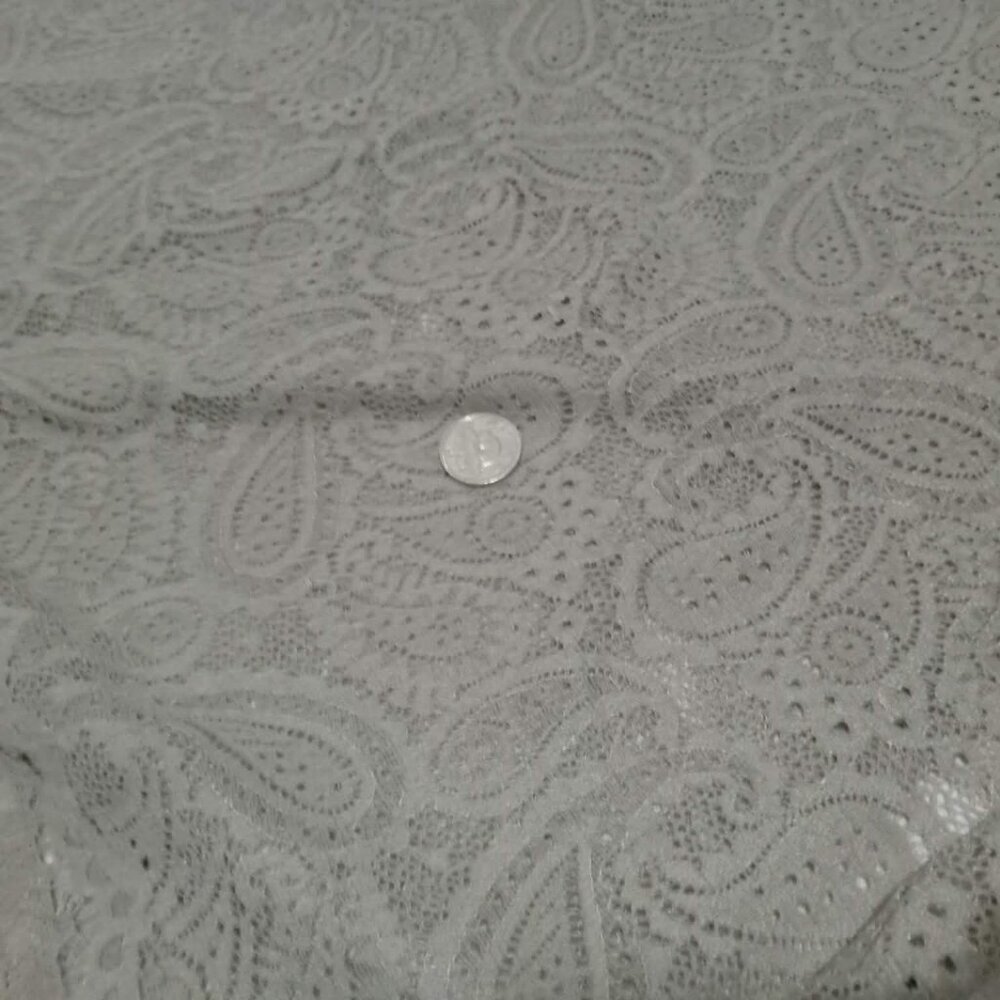 One final piece of stretch lace with a sand-colored paisley pattern fabric